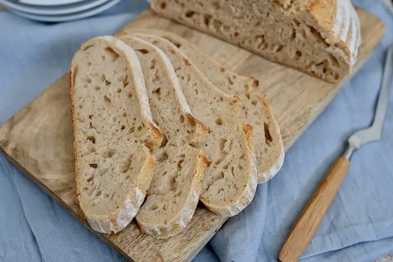 Aufgeschnittenes italienisches Brot mit Lievito Madre auf einem Holzbrett, bereit zum Genießen.